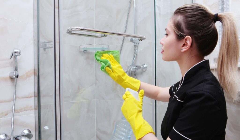 The shower door can be opened by a young girl in a cleaning service suit