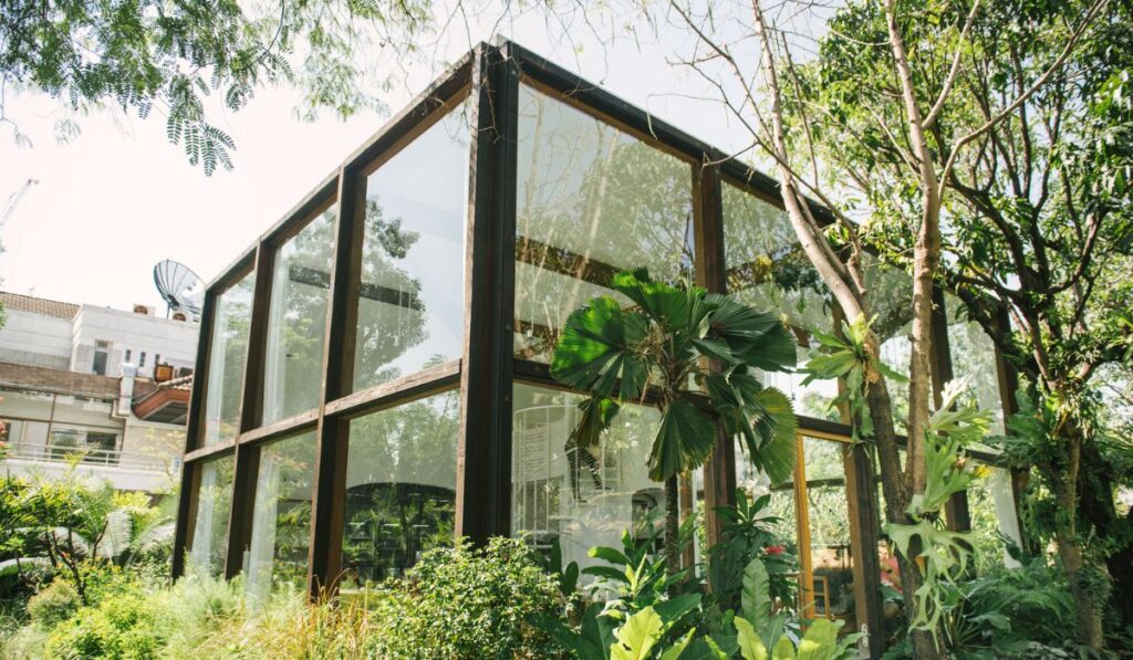 A glass house near green