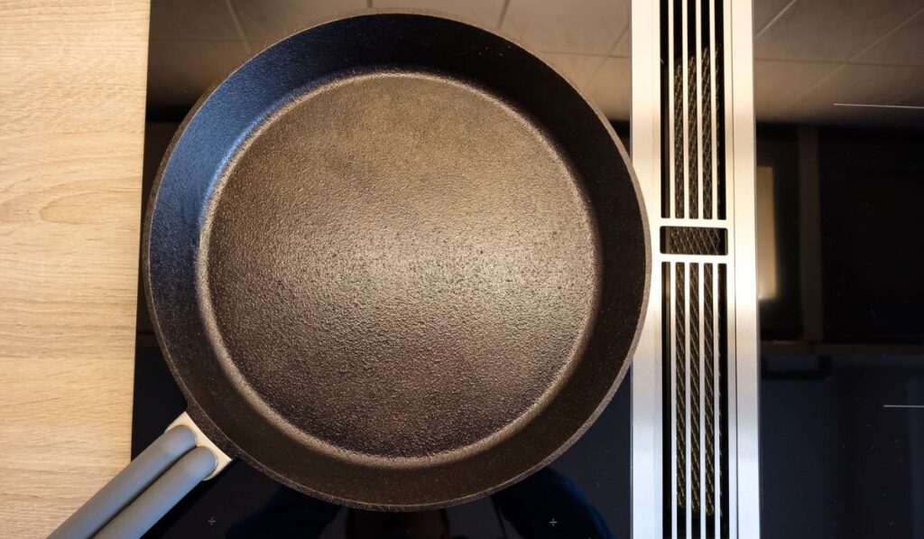 Cast iron frying pan on a glass cooker