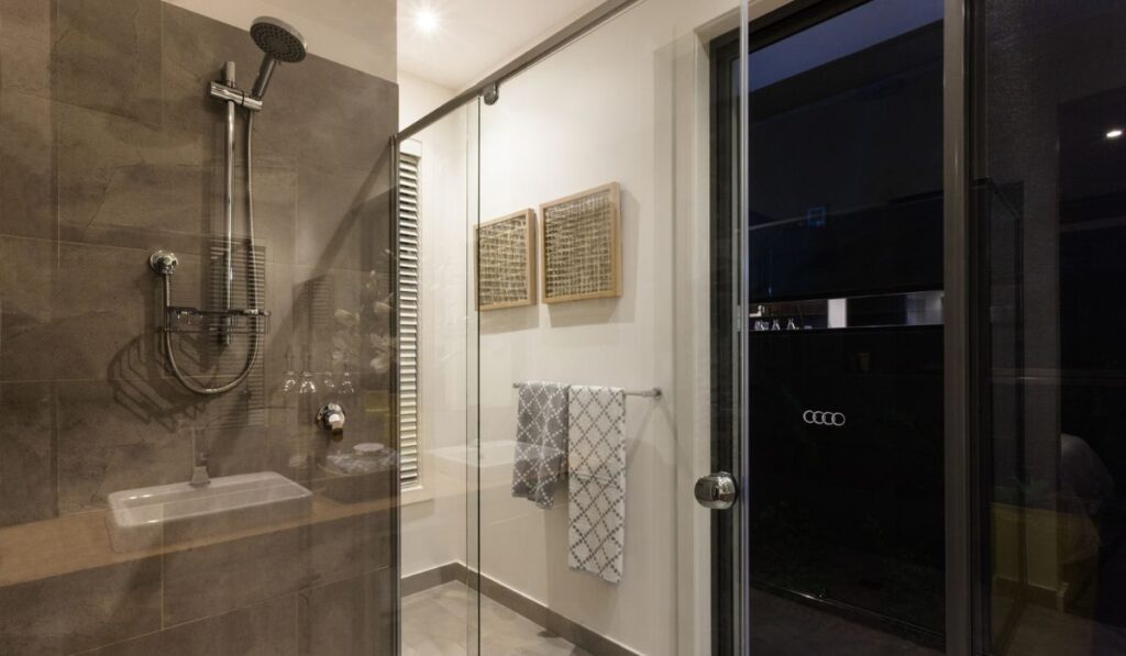 Modern bathroom shower area with glass doors
