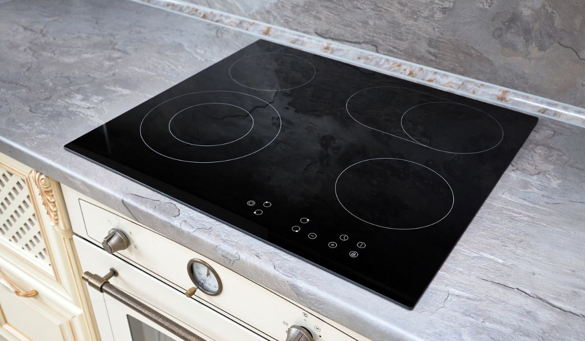 Modern kitchen interior with black induction or electric hob stove cooker with ceramic top