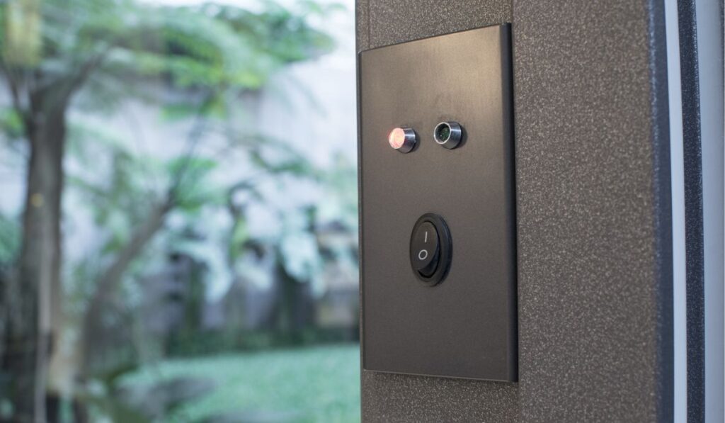A smart lock with manual switch installed on a sliding door going to the backyard of a upscale home