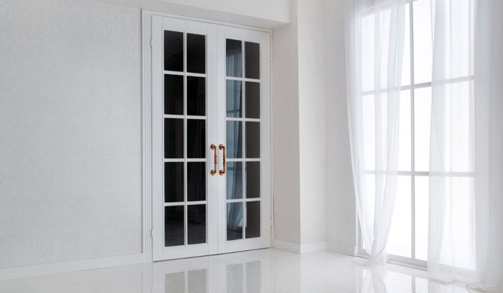 Empty white room with big window and glass french door